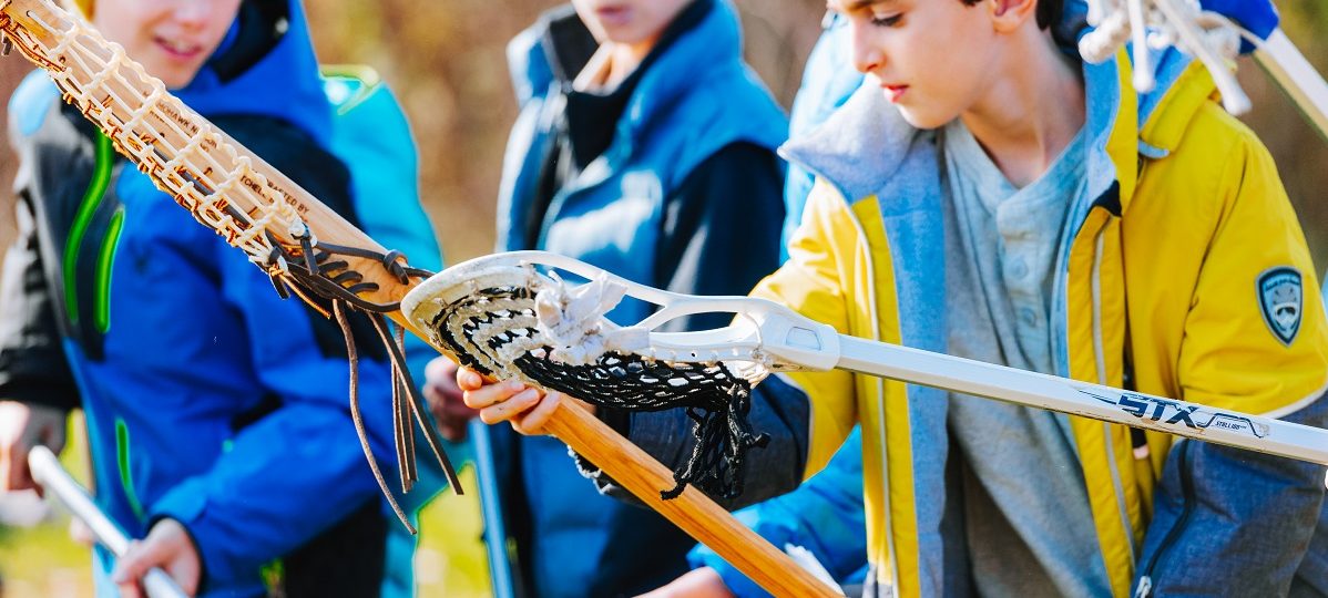 Students playing lacrosse as part of an educational program at Sainte-Marie among the Hurons