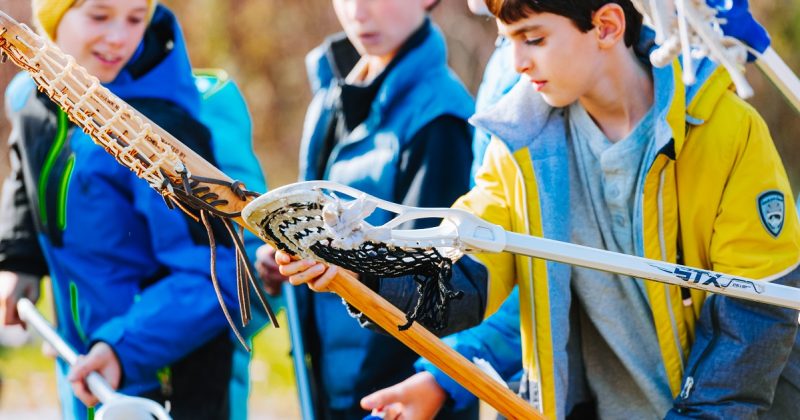 Students playing lacrosse as part of an educational program at Sainte-Marie among the Hurons