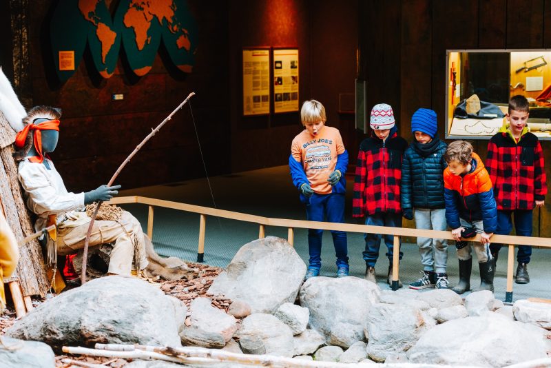 Some young guests checking out the indoor museum main motif, with a river running through it