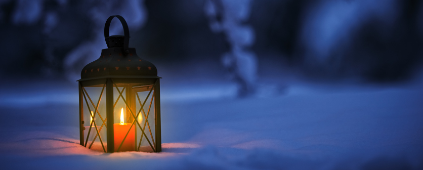 A lit lantern in the snow