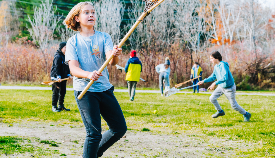 A student learns to play lacrosse as part of an educational program at Sainte-Marie