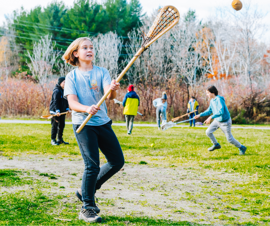 A student learns to play lacrosse as part of an educational program at Sainte-Marie