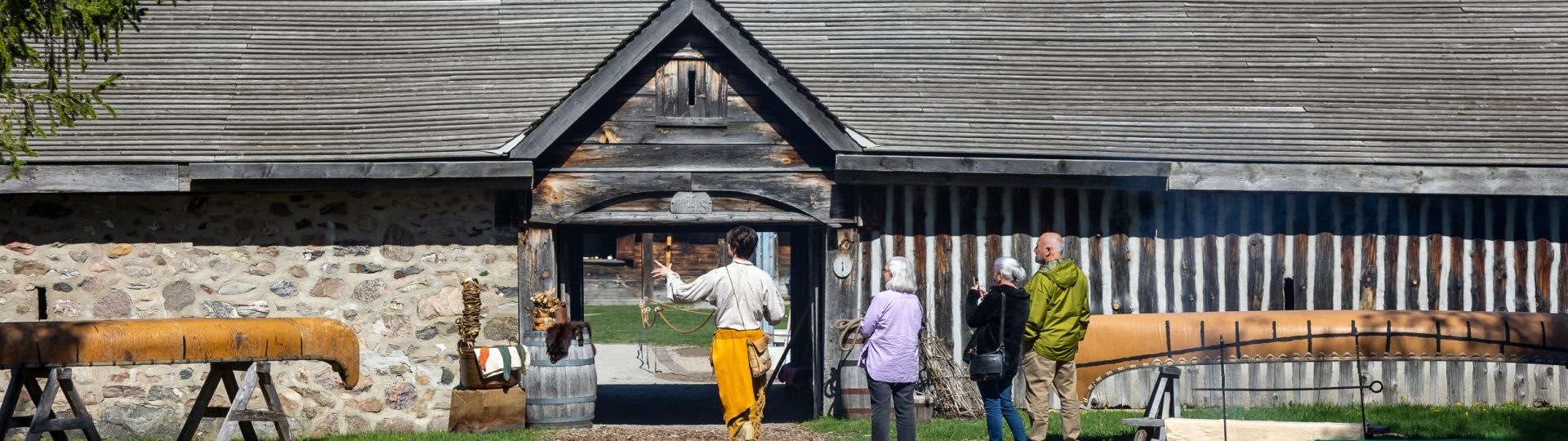 Three young Sainte-Marie visitors play games in the longhouse