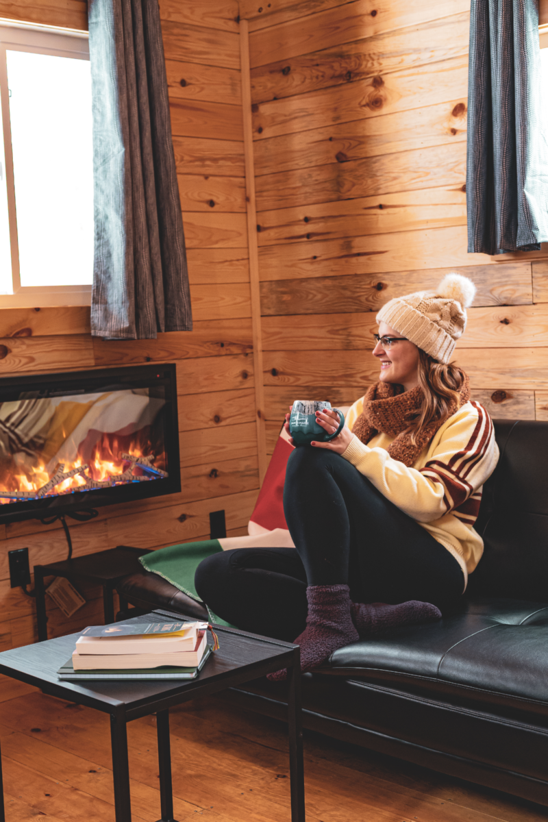 Interpreter walks through the mains gates of the site during a smoky evening tour