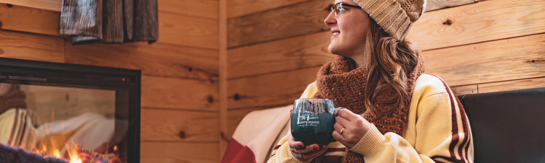 An interpreter points at the main gates of Sainte-Marie while leading three guests in a guided tour